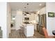 Well-lit kitchen featuring white cabinets, stainless steel appliances, and an inviting breakfast bar at 106 Cottage Way # 33, Pittsboro, NC 27312