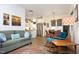 Open concept living area shows a green sofa, a modern kitchen, and a dining area bathed in natural light at 106 Cottage Way # 33, Pittsboro, NC 27312
