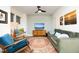 Stylish living room featuring a comfortable green sofa, accent chairs, decorative rug, and a TV mounted on the wall at 106 Cottage Way # 33, Pittsboro, NC 27312