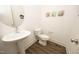 Elegant powder room featuring a pedestal sink, modern fixtures, and stylish decor at 106 Cottage Way # 33, Pittsboro, NC 27312