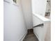 Descending wooden staircase with white walls and trim, carpet landing on second floor at 106 Cottage Way # 33, Pittsboro, NC 27312