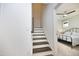 Light and bright staircase with wood treads and white risers, leading to second floor at 106 Cottage Way # 33, Pittsboro, NC 27312