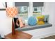 Inviting window seat is adorned with an array of decorative pillows, creating a cozy reading nook with natural light at 106 Cottage Way # 33, Pittsboro, NC 27312