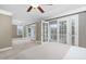 Bright bedroom with white carpet, ceiling fan, white trim, and french doors to a private balcony at 1068 Tender Dr, Apex, NC 27502