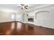 Bright living room with modern fireplace, custom built-ins, ceiling fan and hardwood floors at 1068 Tender Dr, Apex, NC 27502