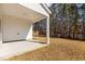 The covered porch overlooks a spacious backyard with a view of mature trees at 1107 Depot Dr, Durham, NC 27703