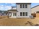 A view of the home's rear exterior with a covered patio and ample backyard space at 1107 Depot Dr, Durham, NC 27703