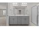 Bathroom featuring a double sink vanity, large mirror, and a glass-enclosed shower at 1107 Depot Dr, Durham, NC 27703
