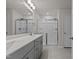 Bathroom featuring a double sink vanity, large mirror, and a glass-enclosed shower at 1107 Depot Dr, Durham, NC 27703