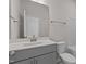 Modern bathroom featuring gray vanity, large mirror, and a toilet with a shower and tub combo at 1107 Depot Dr, Durham, NC 27703
