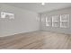 Empty bedroom featuring hardwood floors, three windows allowing natural light in to brighten the space at 1107 Depot Dr, Durham, NC 27703