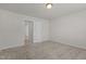 Inviting bedroom boasts neutral carpet, a ceiling light, and easy access to an adjacent room at 1107 Depot Dr, Durham, NC 27703