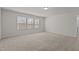 Bright bedroom with three windows providing natural light and plush carpeting at 1107 Depot Dr, Durham, NC 27703