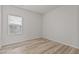 Empty bedroom features hardwood floors and a window allowing natural light in to brighten the space at 1107 Depot Dr, Durham, NC 27703