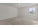 Cozy bedroom with a single window and neutral carpeting at 1107 Depot Dr, Durham, NC 27703