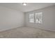 Cozy bedroom with neutral carpet, large windows offering natural light, and ample space at 1107 Depot Dr, Durham, NC 27703