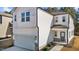 Bright two-story home featuring a white exterior, a gray front door, and an attached two-car garage at 1107 Depot Dr, Durham, NC 27703