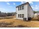 Rear view of a home with a covered patio and a serene pond in the backyard at 1107 Depot Dr, Durham, NC 27703