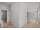 Inviting hallway with neutral walls and wood-look flooring, leading to a bright living area at 1107 Depot Dr, Durham, NC 27703