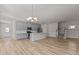 Open concept kitchen with stainless steel appliances, gray cabinets, and stairs leading to the second floor at 1107 Depot Dr, Durham, NC 27703