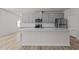 Bright, open kitchen with stainless steel appliances, gray cabinets and a large central island at 1107 Depot Dr, Durham, NC 27703