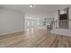 Bright living room featuring hardwood floors, stairs, and an open concept layout with easy access to the kitchen at 1107 Depot Dr, Durham, NC 27703