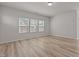 Bright living room featuring hardwood floors, three windows allowing natural light in to brighten the space at 1107 Depot Dr, Durham, NC 27703