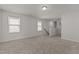 Spacious living room with plush carpet and two windows allowing natural light in to brighten the space at 1107 Depot Dr, Durham, NC 27703