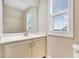 Bathroom with a large mirror, white cabinets and natural light from a window at 1109 Hemby Ridge Ln, Morrisville, NC 27560