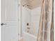 Bathroom featuring a white tub and shower with white tile and neutral walls at 1109 Hemby Ridge Ln, Morrisville, NC 27560