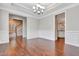 Elegant dining room with hardwood floors, wainscoting, decorative trim, and a chandelier at 1109 Hemby Ridge Ln, Morrisville, NC 27560