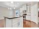 Modern kitchen features stainless appliances, granite counters, white cabinetry, and dark wood floors at 1109 Hemby Ridge Ln, Morrisville, NC 27560