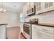 Modern kitchen with stainless steel appliances, white cabinets, and dark countertops with open sightlines at 1109 Hemby Ridge Ln, Morrisville, NC 27560