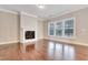Bright living room with fireplace and large windows filling the space with natural light at 1109 Hemby Ridge Ln, Morrisville, NC 27560