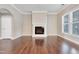 Living room with fireplace, large windows, and hardwood floors, creating a warm and inviting atmosphere at 1109 Hemby Ridge Ln, Morrisville, NC 27560