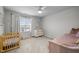 Charming Bedroom with natural light, a toddler bed, a crib, and a changing table at 112 Velten Ridge Dr, Durham, NC 27713