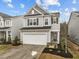 Two-story home featuring a two-car garage, manicured landscaping, and inviting front entrance at 112 Velten Ridge Dr, Durham, NC 27713