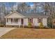 Charming single-story home with a welcoming front porch and well-maintained landscaping at 118 Gracie Ln, Clayton, NC 27520