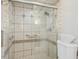 Clean bathroom featuring a glass-door shower with decorative tiling and a neutral color scheme at 14115 Allison Dr, Raleigh, NC 27615