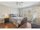 Comfortable bedroom with hardwood floors, a well-made bed, and bright natural light at 14115 Allison Dr, Raleigh, NC 27615