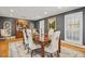Spacious dining room featuring a large wooden table, decorative chairs, and ample natural light at 14115 Allison Dr, Raleigh, NC 27615