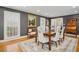 Dining area enhanced by wooden floors, stylish seating, and bright light streaming through the window at 14115 Allison Dr, Raleigh, NC 27615