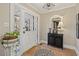 Welcoming entryway featuring tiled flooring, a charming accent mirror, and a stylish black console table at 14115 Allison Dr, Raleigh, NC 27615