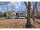 Two-story home with striking black-and-white contrast, complemented by the natural beauty of the surrounding trees at 14115 Allison Dr, Raleigh, NC 27615