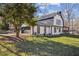Exterior view of house featuring attached garage, with white siding and black trim, and an expansive lawn at 14115 Allison Dr, Raleigh, NC 27615