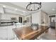Open kitchen and dining space with stainless appliances, granite counters and eat-in breakfast bar at 14115 Allison Dr, Raleigh, NC 27615