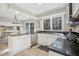 Open kitchen boasts white cabinets, stainless appliances, tile floors and an eat-in area at 14115 Allison Dr, Raleigh, NC 27615