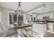 Kitchen and dining area with stainless appliances, tile floors, granite counters and views to the back yard at 14115 Allison Dr, Raleigh, NC 27615