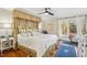 Relaxing main bedroom with a decorative canopy bed, hardwood floors, and bright natural light at 14115 Allison Dr, Raleigh, NC 27615