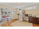 Bright office space featuring hardwood floors, natural light, and a view into the living room at 14115 Allison Dr, Raleigh, NC 27615